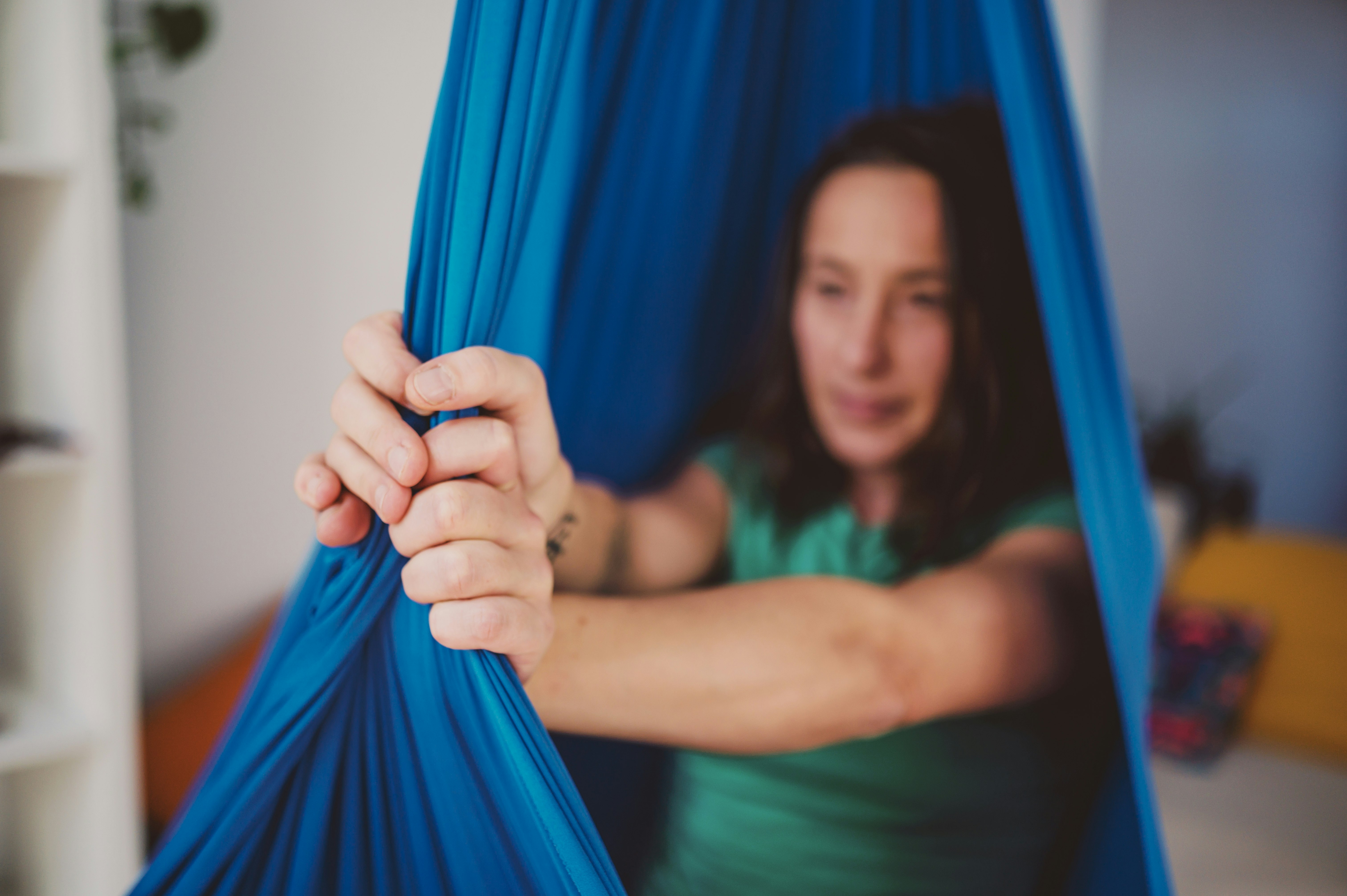 woman in green tank top holding blue textile